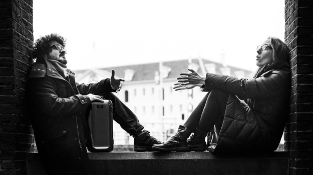 Duo Büyükberber/Hassfurther sitzend auf Fensterbrett.